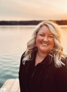 Photo of Jocelyn Hunt with a scenic Ontario lake behind her