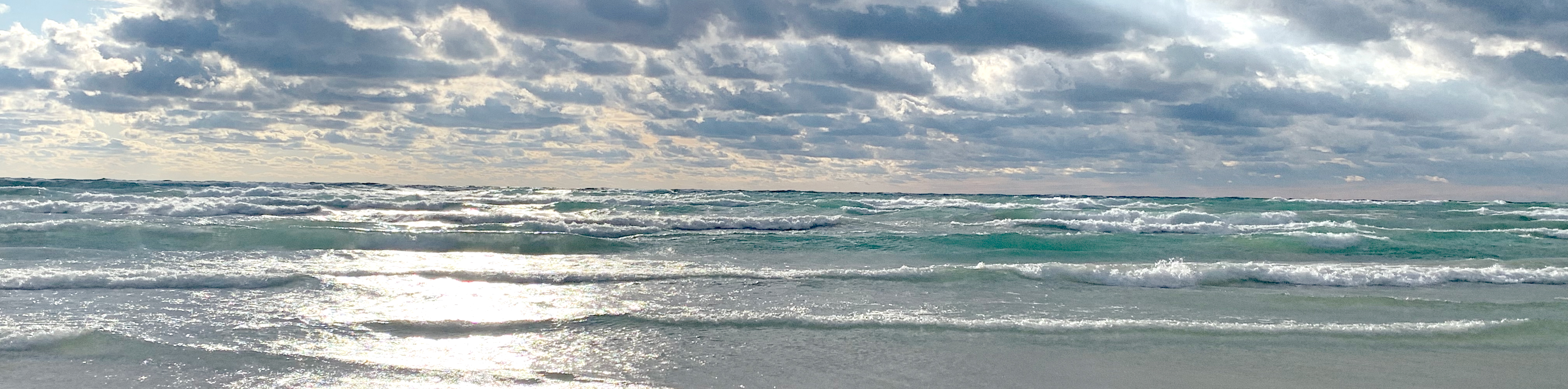 Light blue waves crashing on a cloudy bright day, at Georgian Bay, Ontario